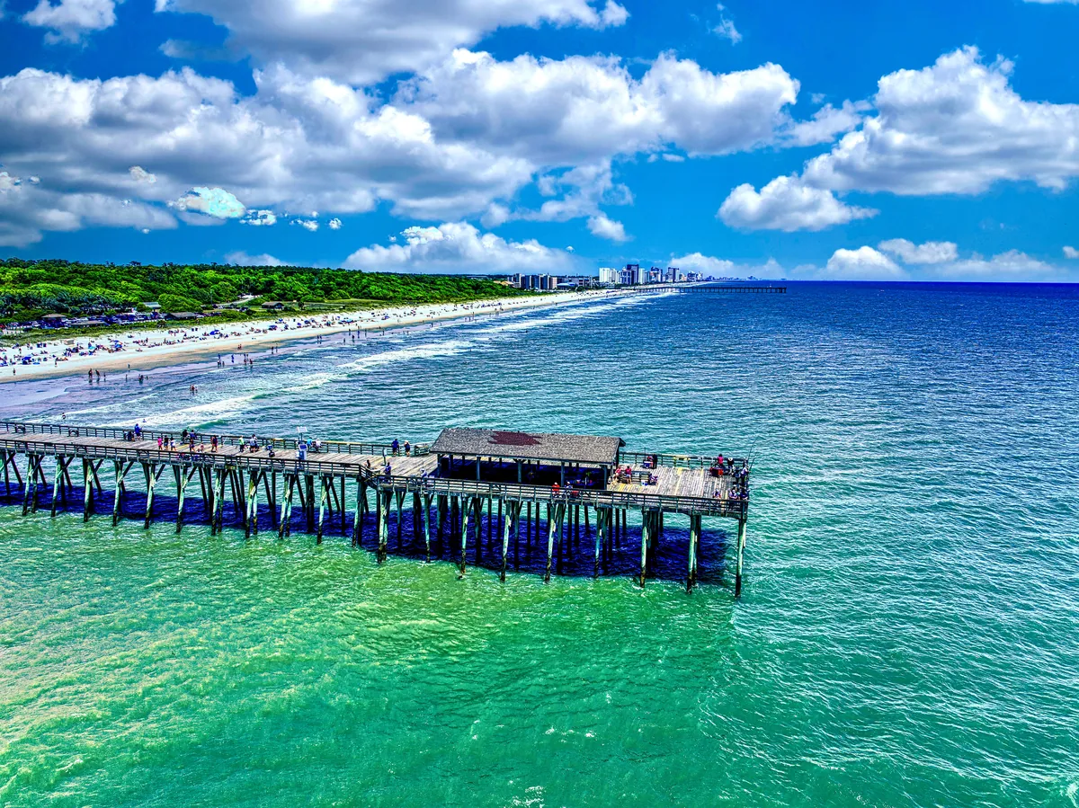 A fishing pier over turquoise water along the Grand Strand
